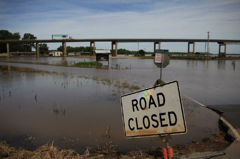 Most roads around Pendleton remain closed and under water Tuesday as the receding Arkansas River remains above flood stage. 