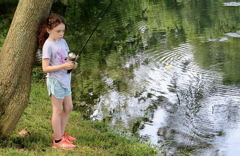 Westside Eagle Observer/RANDY MOLL Lacey Cheek, 7, gets ready to cast her line out into the pond during the fishing derby at the Flint Creek Nature Park in Gentry which was sponsored by the Gentry Chamber of Commerce on Saturday morning.