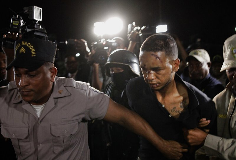 Eddy Vladimir Feliz Garcia, in custody in connection with the shooting of former Boston Red Sox slugger David Ortiz, is transferred by police to court in Santo Domingo, Dominican Republic, Tuesday, June 11, 2019. His lawyer Deivi Solano said Feliz Garcia had no idea who he'd picked up and what was about to happen, and that he expected Feliz Garcia would be charged as an accomplice to an attempted murder. (AP Photo/Roberto Guzman) story.lead_photo.caption