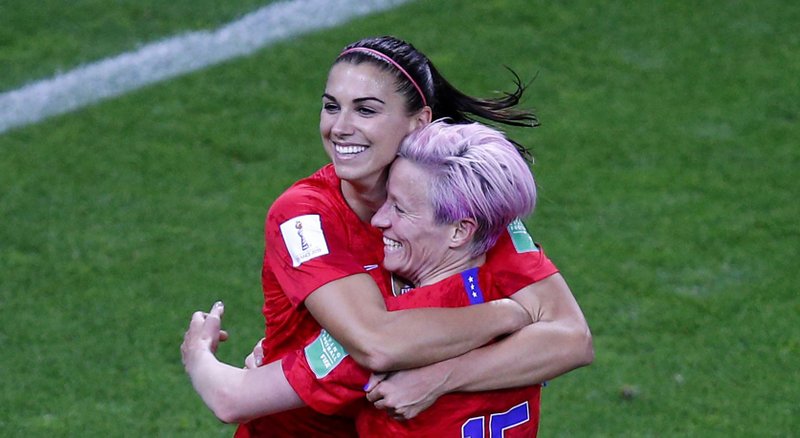 Alex Morgan (left) and teammate Megan Rapinoe embrace after Morgan’s fifth goal in the United States’ 13-0 victory over Thailand on Tuesday in the Women’s World Cup at Reims, France. 