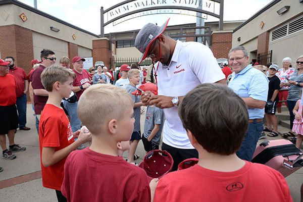 Arkansas pitcher Isaiah Campbell signs autographs for fans outside Baum-Walker Stadium on Wednesday, June 12, 2019, in Fayetteville. 