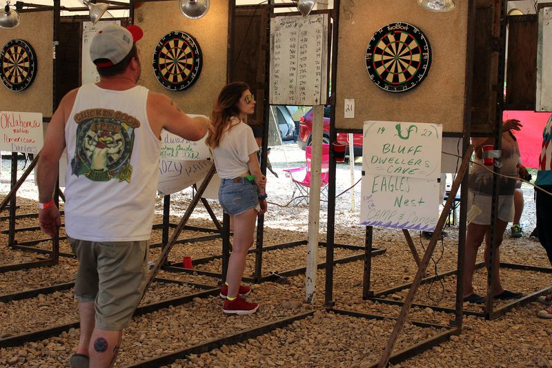 MEGAN DAVIS/MCDONALD COUNTY PRESS Darters of all ages gathered under the white-top tent on Saturday to hone their skills and share their passion, many of them sporting shirts from past Chicken Coop Open events. Local businesses are integral to the event as many of them sponsor dart boards. &quot;Because of these sponsors we're able to keep the Chicken Coop in Noel,&quot; said organizer Mike Edwards.