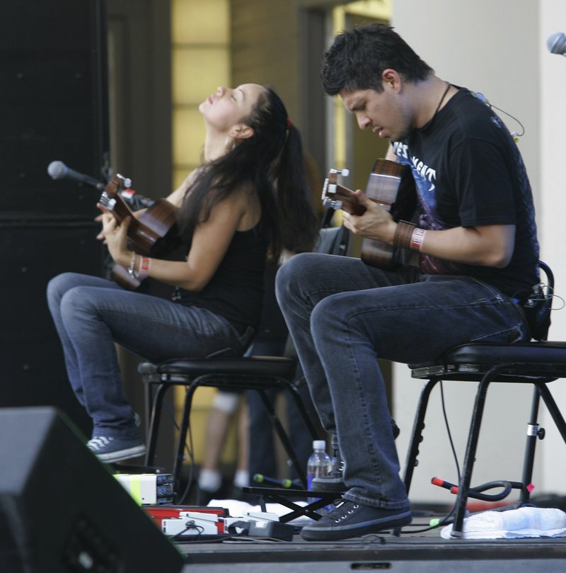 FILE - In this Aug. 5, 2007 file photo, Gabriela Quintero, left, and Rodrigo Sanchez, of the group &quot;Rodrigo Y Gabriela&quot; perform at Lollapalooza at Grant Park in Chicago. Rodrigo Sanchez and Gabriela Quintero, the acoustic, instrumental rock duo who record as Rodrigo y Gabriela, are back with their first album in five years. &#x201c;Mettavolution&#x201d; offers six original tracks and one ambitious cover, a 19-minute version of Pink Floyd&#x2019;s 1971 epic song &#x201c;Echoes.&#x201d; Listening to them play, it&#x2019;s hard to believe two people playing guitars can make music so powerful. It&#x2019;s even harder to believe that they&#x2019;re self-taught.(AP Photo/Brian Kersey, File)