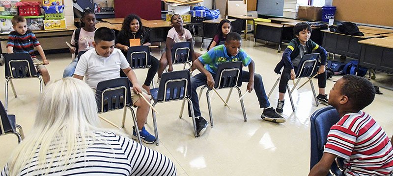 The Sentinel-Record/Grace Brown LITTLE DRUMMERS: Students participate in the first day of the aerobic drumming course offered at the Trojan Summer Academy and YMCA Enrichment Program at Gardner STEM Magnet School on Wednesday.