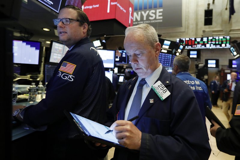 In this May 30, 2019, file photo specialist Gregg Maloney, left, and trader James Riley works on the floor of the New York Stock Exchange.  (AP Photo/Richard Drew, File)