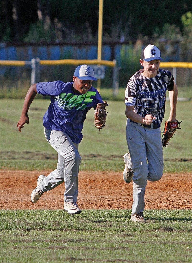 Terrance Armstard/News-Times El Dorado Metals Micah Singleton, left, and Jamison Dumas race to home plate during practice on Thursday. The Metals begin play at the American Legion 15U State Tournament Saturday in Cabot.