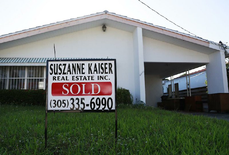 Freddie Mac reported little change this week for long-term mortgage rates on properties such as this home in Surfside, Fla., shown  in April. 