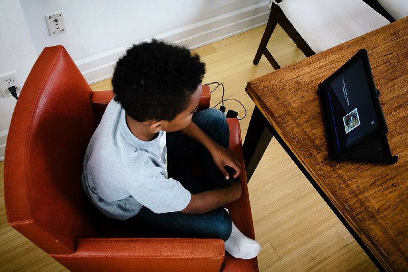 A child in a focus group study in New York uses an Amazon Fire Tablet in May to practice reading using Bamboo Learning Inc.’s voice-activated software. 