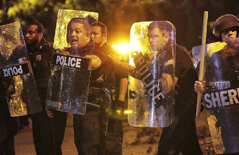 Memphis police face angry protesters Wednesday in the Frayser community after a youth was shot by U.S. marshals. 