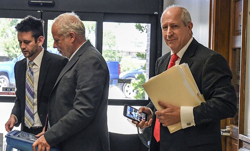 The Sentinel-Record/Grace Brown DAY IN COURT: State Rep. Mickey Gates, R-District 22, right, enters the Garland County Court House Thursday with his attorney, Jeff Rosenzweig, center, for a pretrial hearing. Gates is charged with failing to pay state income taxes or failing to file income tax returns from 2012 to 2017. His trial is scheduled for July 29.