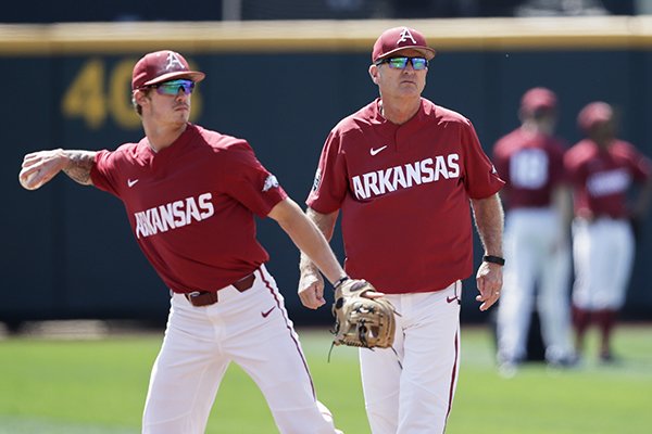 Arkansas NCAA college baseball coach Dave Van Horn, right, follows team practice at TD Ameritrade Park, as Casey Martin throws in Omaha, Neb., Friday, June 14, 2019. (AP Photo/Nati Harnik)

