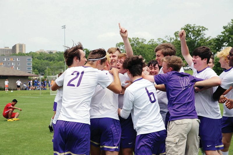 The Central Arkansas Christian Mustangs celebrate after they beat Green Forest to win the 