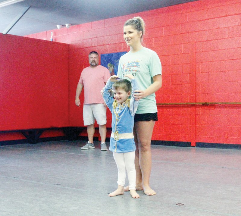 Duane Peckat, back, watches his daughter, Madison, work with his grandson Andy Eason at Lana’s Dance Studio. Peckat said he hasn’t missed a dance competition or recital since his children and grandchildren started dancing.