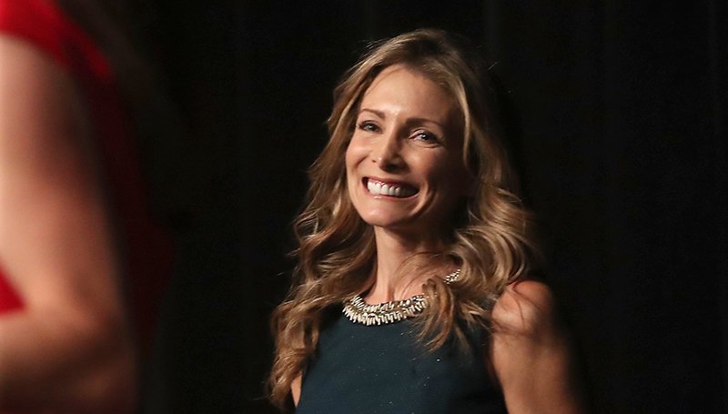 The Sentinel-Record/Richard Rasmussen OLYMPIAN: Olympic medalist Shannon Miller listens as she is introduced at the Arkansas Bar Association meeting at the Hot Springs Convention Center on Thursday.