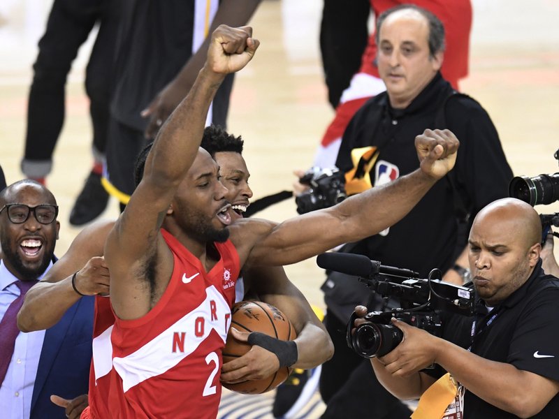 The Associated Press FIRST RAPTOR TITLE: Toronto Raptors forward Kawhi Leonard (2) and guard Kyle Lowry, back, celebrate Thursday after the Raptors defeated the Golden State Warriors 114-110 in Game 6 of the NBA Finals in Oakland, Calif.