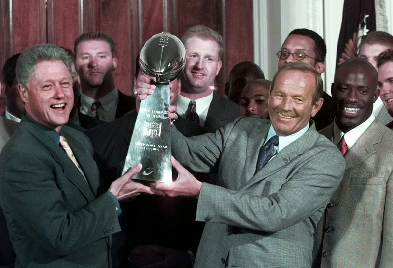 Then-President Bill Clinton (left) and Denver Broncos owner Pat Bowlen hold the Vince Lombardi Trophy June 16, 1998, during a ceremony at the White House where the president honored the Super Bowl XXXII champions.