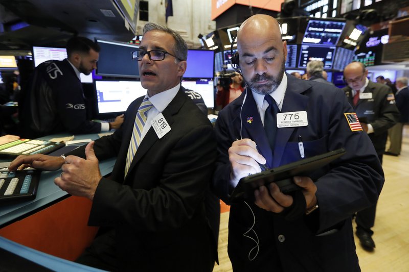 FILE - In this June 6, 2019, file photo specialist Anthony Rinaldi, left, and trader Fred DeMarco work on the floor of the New York Stock Exchange. The U.S. stock market opens at 9:30 a.m. EDT on Friday, June 14. (AP Photo/Richard Drew, File)