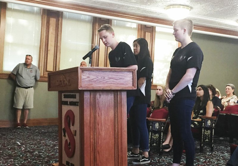 James Cassady, from left, Abby Herrera and Sara Manos, members of the Root Negative One robotics team at Springdale's Tyson School of Innovation, speak at the Springdale School Board meeting on Tuesday, June 11, 2019.