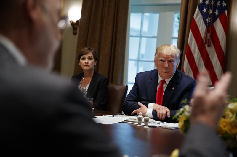 Iowa Gov. Kim Reynolds and President Donald Trump listen as Pennsylvania Gov. Tom Wolf speaks during a meeting with governors on &quot;workforce freedom and mobility&quot; in the Cabinet Room of the White House, Thursday, June 13, 2019, in Washington. (AP Photo/Evan Vucci)