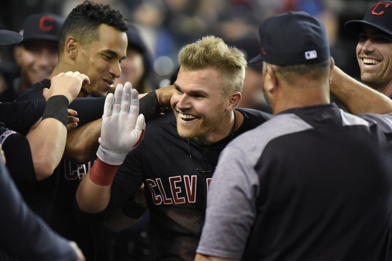 Cleveland Indians' Jake Bauers, center, is congratulated by teammates after hitting a two-run home run against the Detroit Tigers in the top of the eighth inning of a baseball game, Friday, June 14, 2019, in Detroit. (AP Photo/Jose Juarez)