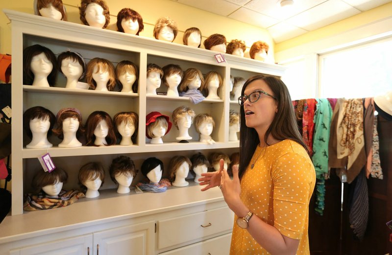 NWA Democrat-Gazette/DAVID GOTTSCHALK Kelsey Brock, program coordinator at the Washington Regional Cancer Support Home, describes Monday what is available in the boutique at the home in Fayetteville. Washington Regional plans to build a new Cancer Support Home. Cancer patients can stay there for free while they're in town getting treatment, come there for counseling or art therapy, buy wigs and mastectomy bras, etc.