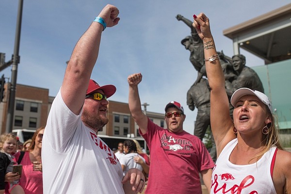 Seth Brown and Kellie Diedrich of Yukon, Okla. (from left) call the hogs after getting married during game two of the NCAA College World Series, Saturday, June 15, 2019 at the TD Ameritrade Park in Omaha, Neb. Seth Brown and Kellie Diedrich of Yukon, Okla. (from left) call the hogs after getting married during game two of the NCAA College World Series, Saturday, June 15, 2019 at the TD Ameritrade Park in Omaha, Neb.
