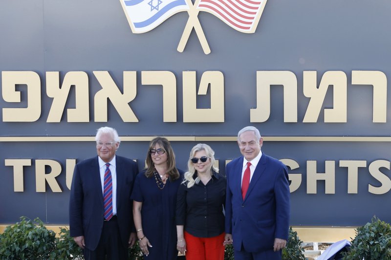 Israeli Prime Minister Benjamin Netanyahu, right, his wife Sara , United States Ambassador to Israel David Friedman, left, his wife Tammy pose during the inauguration of a new settlement named after President Donald Trump in the Golan Heights, Sunday, June 16, 2019. The Trump name graces apartment towers, hotels and golf courses. Now it is the namesake of a tiny Jewish settlement in the Israeli-controlled Golan Heights.