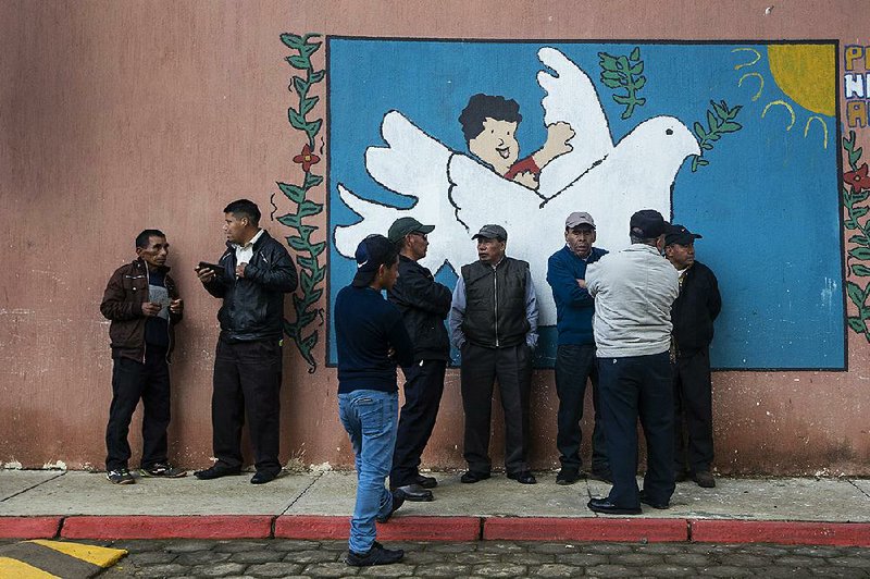 People line up to vote Sunday at a polling station in Sumpango, Guatemala.