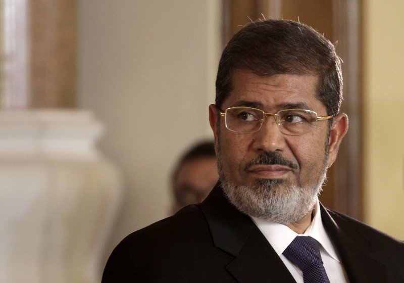 In this July 13, 2012 photo, Egyptian President Mohammed Morsi holds a news conference with Tunisian President Moncef Marzouki, at the Presidential palace in Cairo, Egypt. On Monday, June 17, 2019, Egypt's state TV said that the country's ousted President Mohammed Morsi has collapsed during a court session and died. (AP Photo/Maya Alleruzzo, File)