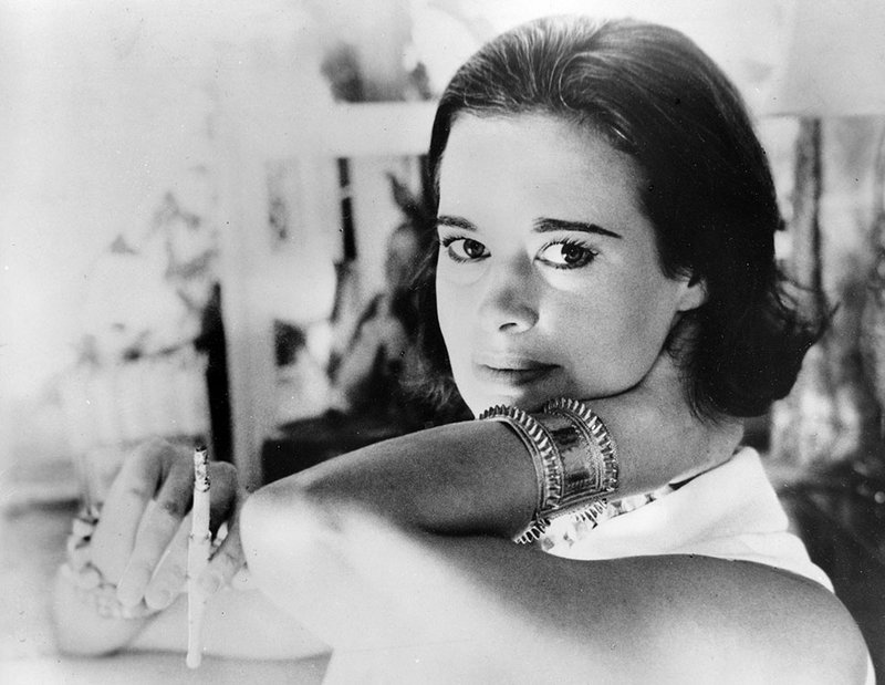 In this Jan. 4, 1964 file photo, railroad heiress Gloria Vanderbilt poses for a photograph. Vanderbilt, the intrepid heiress, artist and romantic who began her extraordinary life as the "poor little rich girl" of the Great Depression, survived family tragedy and multiple marriages and reigned during the 1970s and '80s as a designer jeans pioneer, died Monday, June 17, 2019, at the age of 95. (AP Photo, File)
