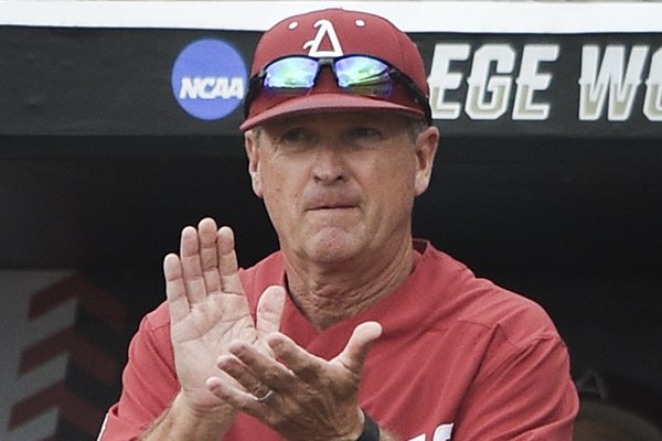 Arkansas coach Dave Van Horn watches from the dugout during a College World Series game against Texas Tech on Monday, June 17, 2019, in Omaha, Neb.
