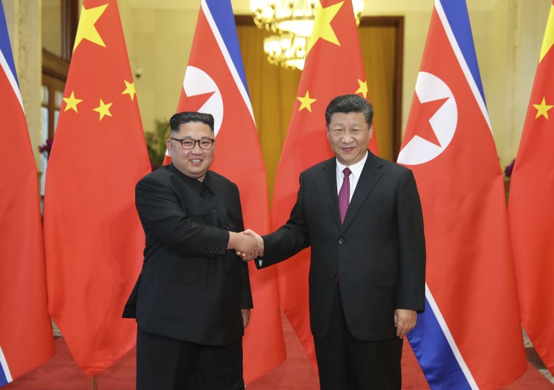 In this June 19, 2018, file photo released by China's Xinhua News Agency, Chinese President Xi Jinping, right, poses with North Korean leader Kim Jong Un for a photo during a welcome ceremony at the Great Hall of the People in Beijing. Chinese state media say President Xi Jinping will make a state visit to North Korea this week. State broadcaster CCTV said in its evening news program on Monday that Xi will meet with North Korean leader Kim Jong Un during a visit Thursday and Friday.