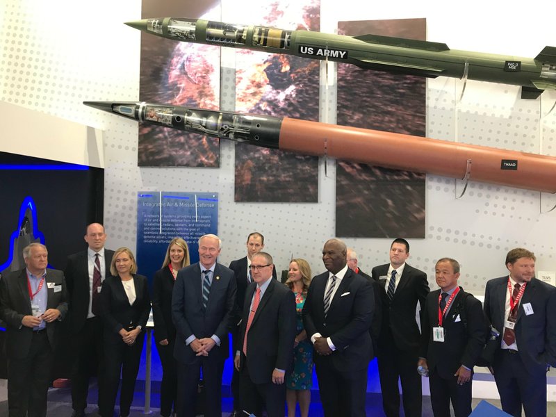 A photo posted Monday morning from Gov. Asa Hutchinson's official Twitter account shows the state official (front, center left) standing with company personnel and the caption: "Exciting to announce ⁦LockheedMartin's⁩ $142 million investment and 326 jobs in Camden to make a new line of defense system rockets and weapons.  This is great news for South Arkansas."