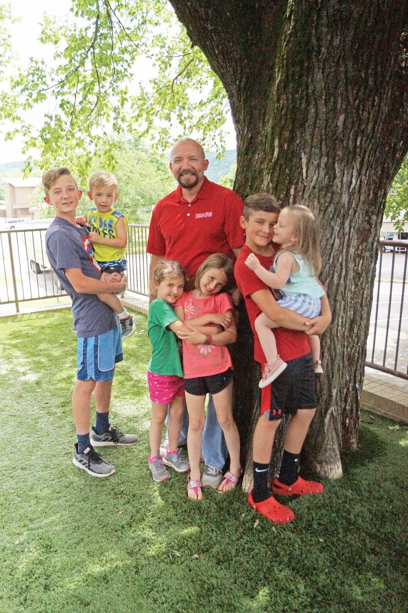 The Rev. JoJo Riggs of Heber Springs said being a dad is his favorite role in life. He and his wife, Andrea, have two biological sons and four adopted children — two sets of siblings. Pictured with Riggs are Eli, 13, left, holding Seth, 3; and standing, from left, Prudence, 5; Lilie, 6; and Josiah, 10, holding Kadie, 2.