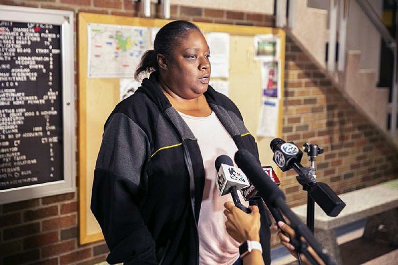 Shafonia Logan, the widow of Eric Logan, speaks with reporters Sunday in South Bend, Ind.
