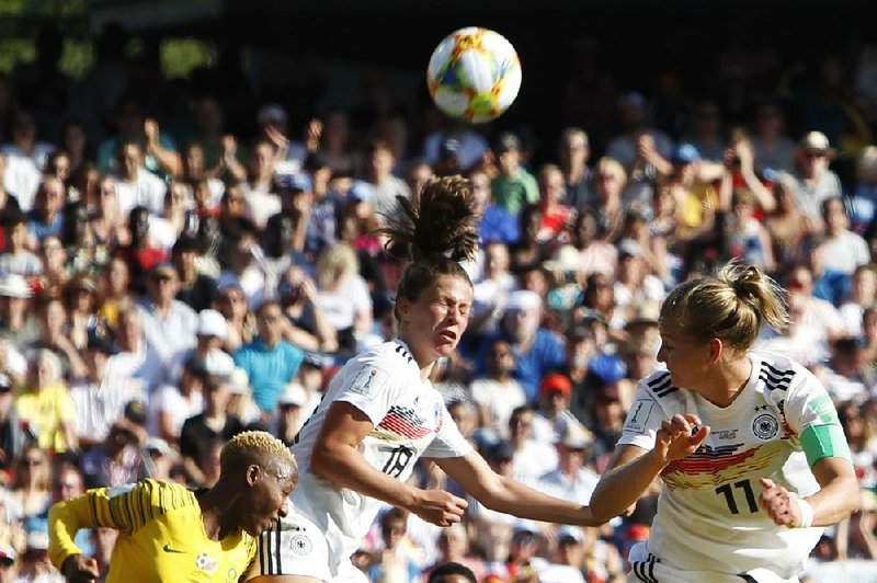 Germany’s Alexandra Popp (right) scores her team’s third goal during a 4-0 victory over South Africa on Monday in Montpellier, France.