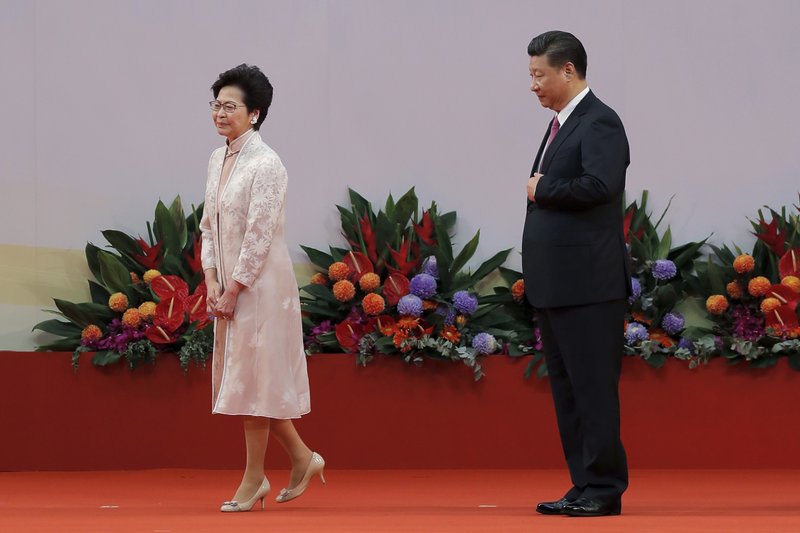 FILE - In this Saturday, July 1, 2017, file photo, Chinese President Xi Jinping, right, looks at Hong Kong's new Chief Executive Carrie Lam after administering the oath for a five-year term in office at the Hong Kong Convention and Exhibition Center in Hong Kong. (AP Photo/Kin Cheung, File)