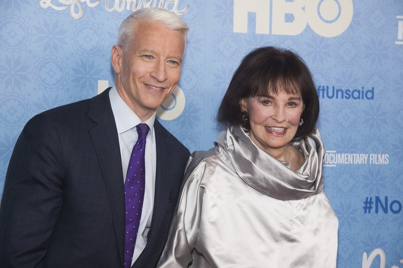 FILE - In this April 4, 2016 file photo, CNN anchor Anderson Cooper and Gloria Vanderbilt attend the premiere of &quot;Nothing Left Unsaid&quot; at the Time Warner Center in New York. Vanderbilt, the &quot;poor little rich girl&quot; heiress at the center of a scandalous custody battle of the 1930s and the designer jeans queen of the 1970s and '80s, died on Monday, June 17, 2019, at 95, according to her son, Cooper. (Photo by Charles Sykes/Invision/AP, File)