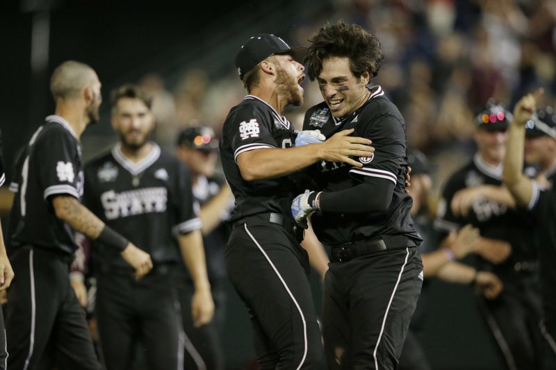 The Associated Press BULLDOG LOVE: Mississippi State's Marshall Gilbert, right, is hugged by Luke Hancock after Gilbert drove in the winning run against Auburn in the ninth inning of Sunday's NCAA College World Series game in Omaha, Neb. Mississippi State won 5-4.