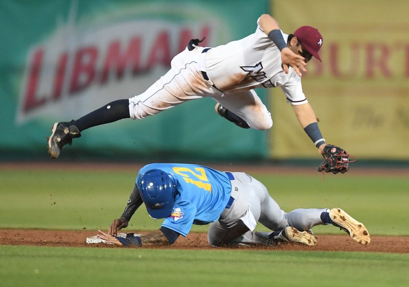 NWA Democrat-Gazette/J.T. WAMPLER The Naturals' Gabriel Cancel can't make the catch as Amarillo's Buddy Reed slides into second base Monday June 17, 2017 at Arvest Ballpark in Springdale.