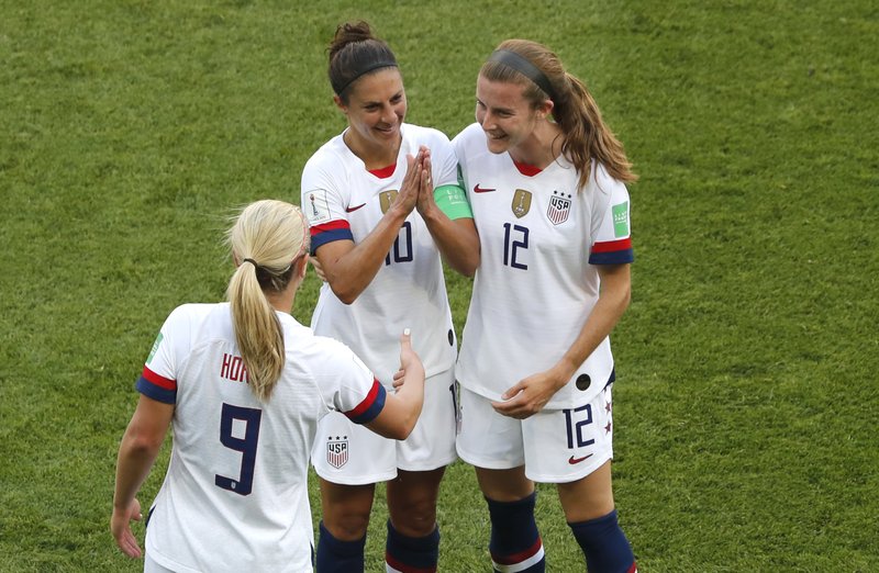 SENDING A MESSAGE: United States' Carli Lloyd, center, celebrates with Lindsey Horan and Tierna Davidson, right, after scoring the opening goal during the Women's World Cup Group F soccer match against Chile Sunday at the Parc des Princes in Paris.