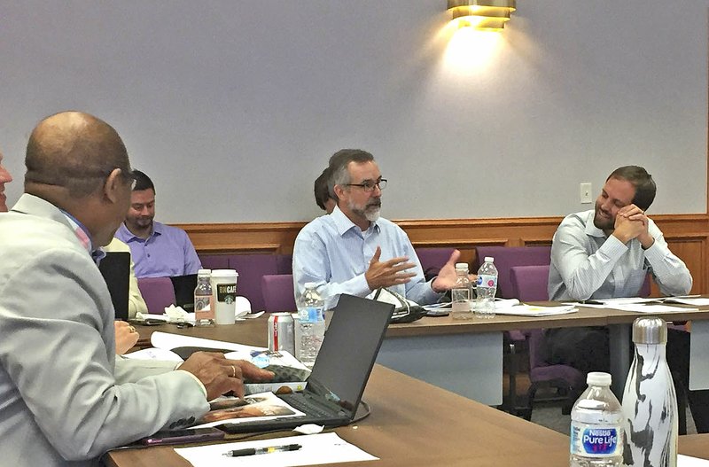 NWA Democrat-Gazette/DAVE PEROZEK Tim Hudson of the Fayetteville School Board makes a point during Monday's board work session as Superintendent John L Colbert, left, and board member Keaton Smith listen.