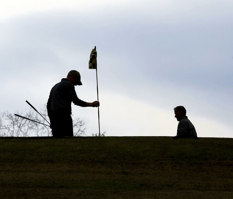 Golfers set up to putt on the 16th green at Little Rock’s War Memorial Golf Course in March of 2018. For budget reasons and over  the objections of golfers, the city has decided to close the War Memorial course and the one at Hindman Park. The Hindman course  will close June 28; the War Memorial course’s last day will be July 4.