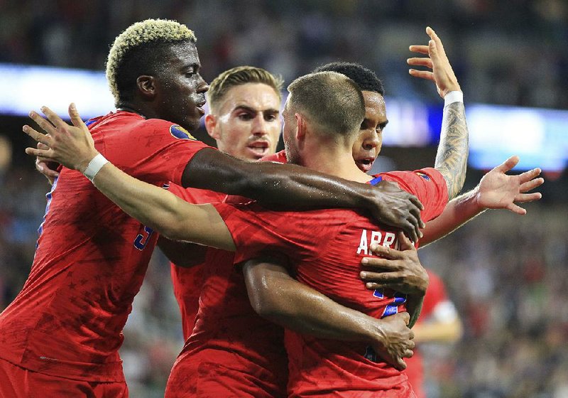 Paul Arriola (7) celebrates with teammates Gyasi Zardes (left,) Tyler Boyd (center) and Weston Mckennie (back right) after scoring a goal in the United States’ 4-0 victory over Guyana on Tuesday in the CONCACAF Gold Cup in St. Paul, Minn. 