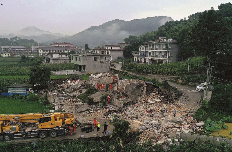 Rescue workers search Tuesday for people trapped under a collapsed building after an earthquake in Shuanghe Town in southwest China’s Sichuan Province, in this photo released by the Xinhua News Agency. 