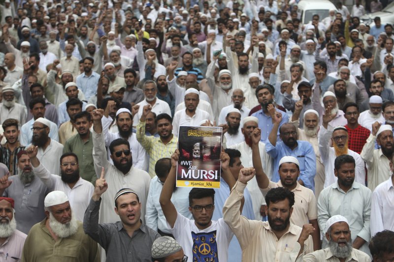 Supporters of the Pakistani religious party Jamaat-i-Islami, gather to offer a funeral prayer in absentia for ousted former Egyptian President Mohammed Morsi, in Karachi, Pakistan. Tuesday, June 18, 2019. Morsi, Egypt's first democratically elected president ousted by the military in 2013, collapsed during a trial session in Cairo on Monday and died. (AP Photo/Fareed Khan)