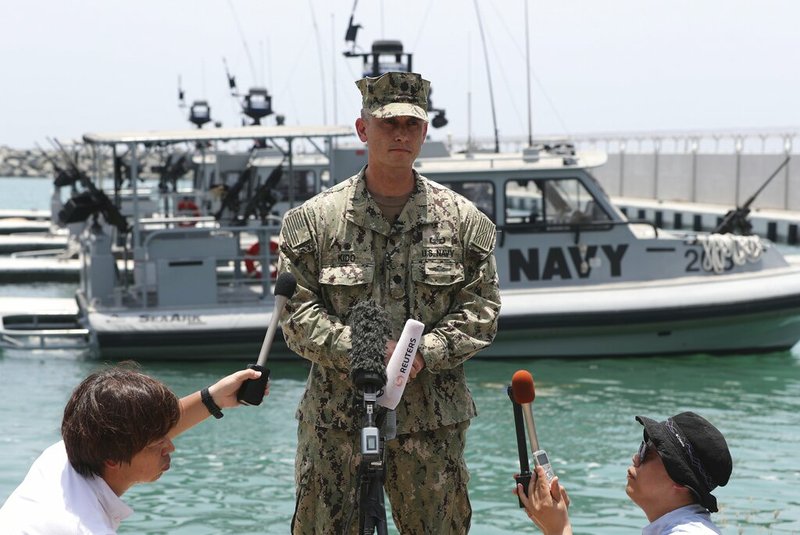 Cmdr. Sean Kido of the U.S. Navy's 5th Fleet talks to journalists at a 5th Fleet Base near Fujairah, United Arab Emirates, Wednesday, June 19, 2019. Cmdr. Kido said Wednesday that damage done last week to the Kokaku Courageous was "not consistent with an external flying object hitting the ship." (AP Photo/Kamran Jebreili)
