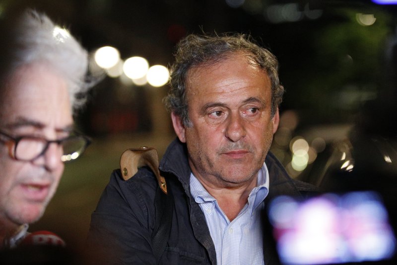 Michel Platini and his lawyer William Bourdon, left, answer reporters after Platini has been freed, outside the French police anti-corruption and financial crimes office in Nanterre, outside Paris, early Wednesday, June 19, 2019. Former UEFA president Michel Platini proclaimed his innocence during police questioning Tuesday following his arrest as part of a corruption probe into the vote that gave the 2022 World Cup to Qatar. 