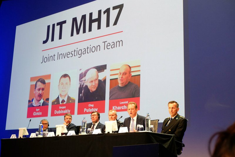 Officials from the Joint Investigation Team probing the downing of Malaysia Airlines Flight 17 in 2014 appear at a press conference in Nieuwegein, Netherlands, on Wednesday, June 19, 2019. The international investigation team charged three Russians and a Ukrainian separatist with the murder of 298 people on board the plane that was shot down over Ukraine. The case is set to start in March 2020. (AP Photo/Mike Corder)
