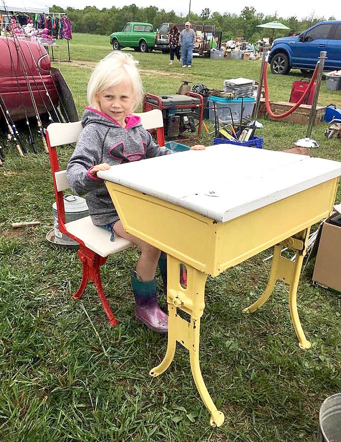 Courtesy photo Quincy Morgan, granddaughter of Vicki and Darwin Smith, &quot;tries on&quot; an old school desk for size at a recent swap meet.